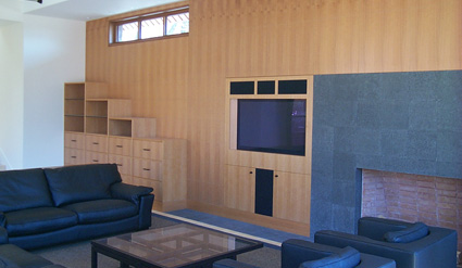 Bookcase, decorative paneling and fireplace surround:  Natural anigre.